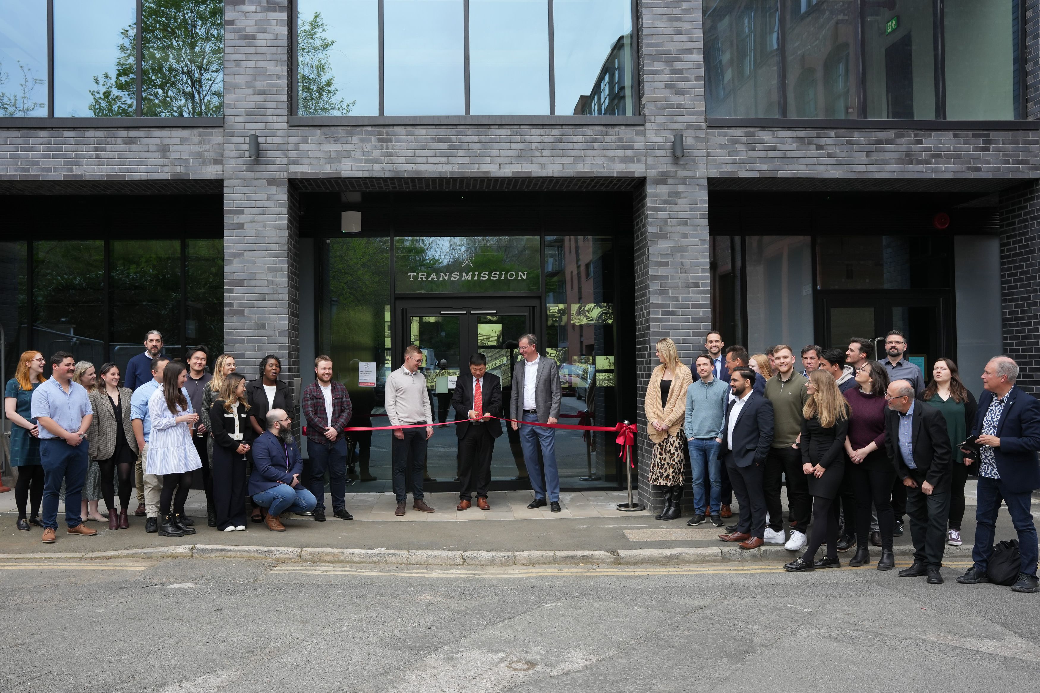 Proteintech ribbon cutting ceremony outside Transmission building